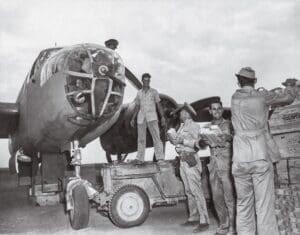 Men of the 12th Bomb Group, based in Italy, unload candy, supplies, and cigarettes.